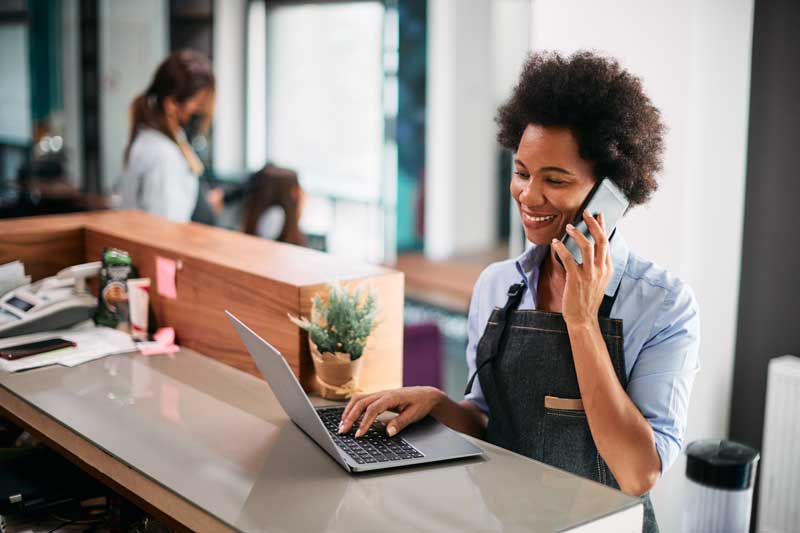 Salon owner signing up on laptop